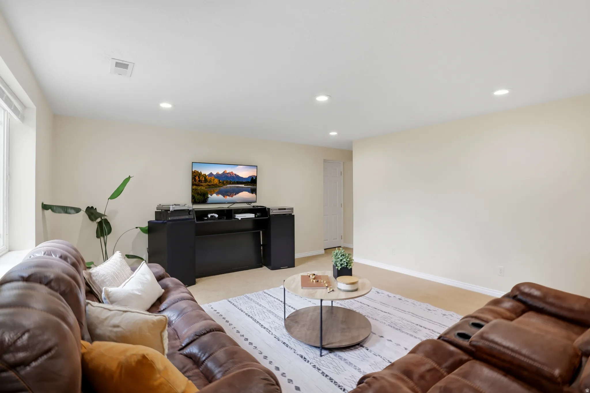 Living area featuring recessed lighting and light carpet