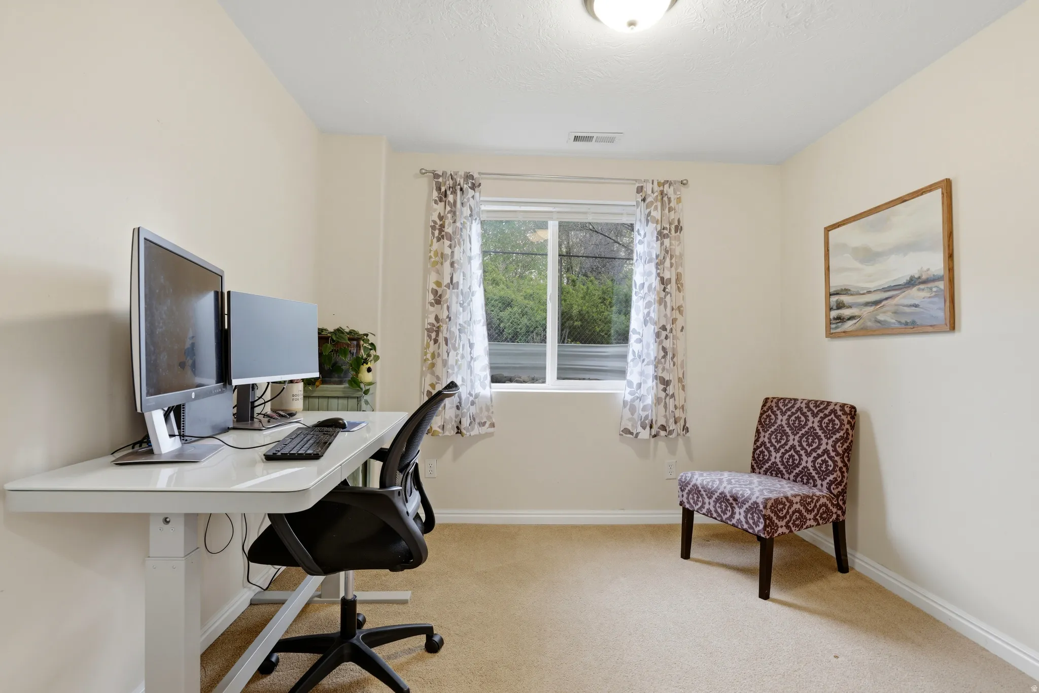 Office space featuring light carpet and baseboards