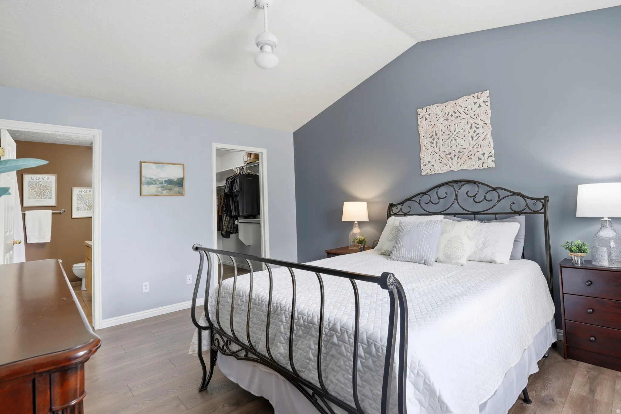 Bedroom featuring wood finished floors and a walk in closet