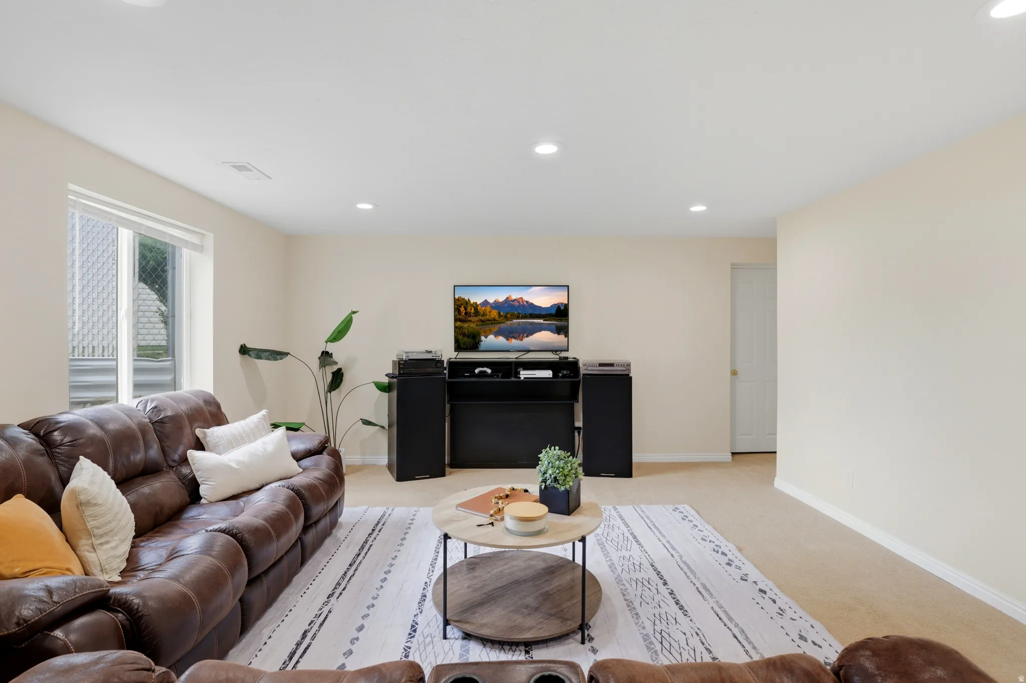 Living area featuring light carpet and recessed lighting