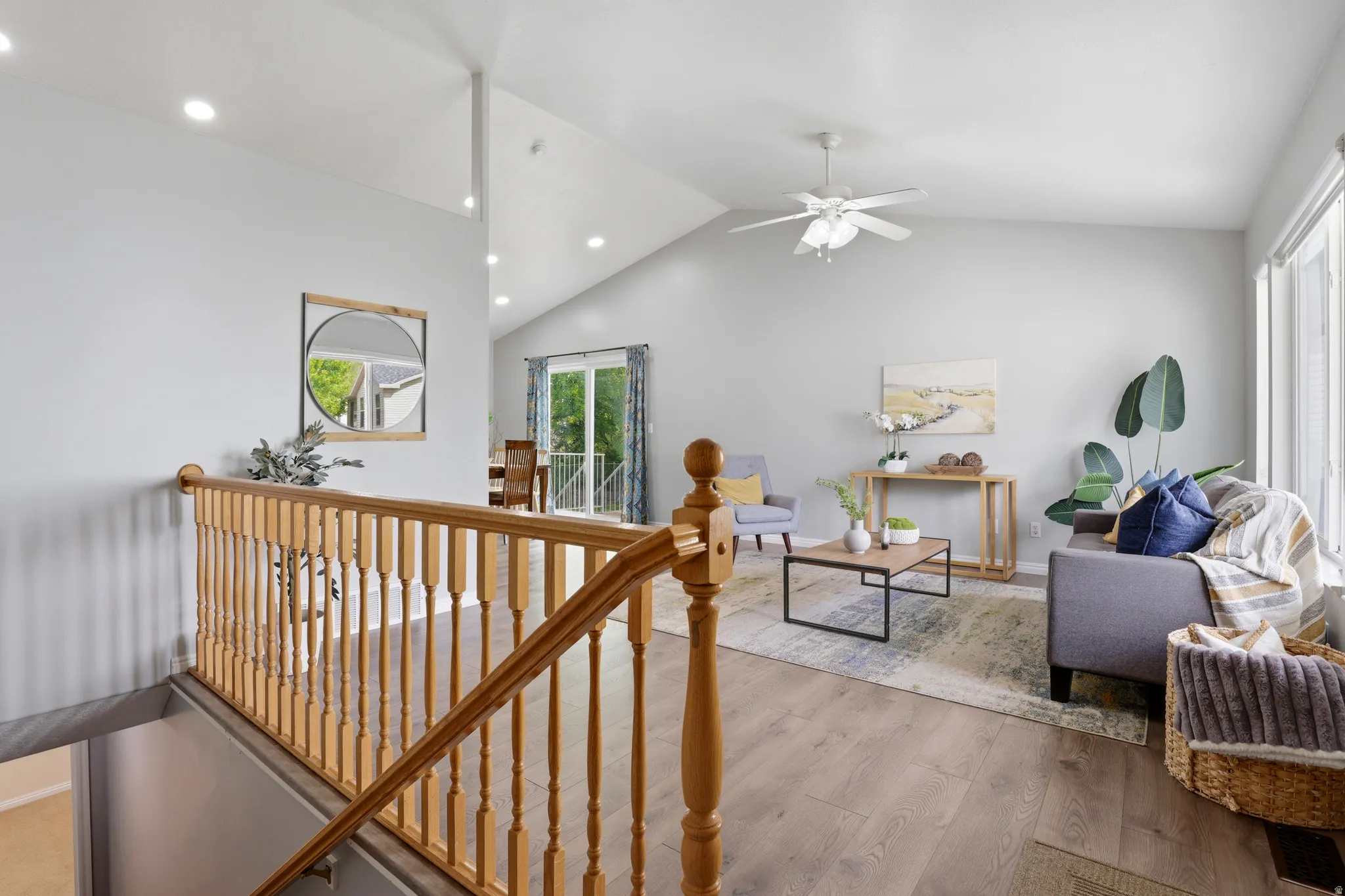 Interior space featuring an upstairs landing, wood finished floors, recessed lighting, and ceiling fan