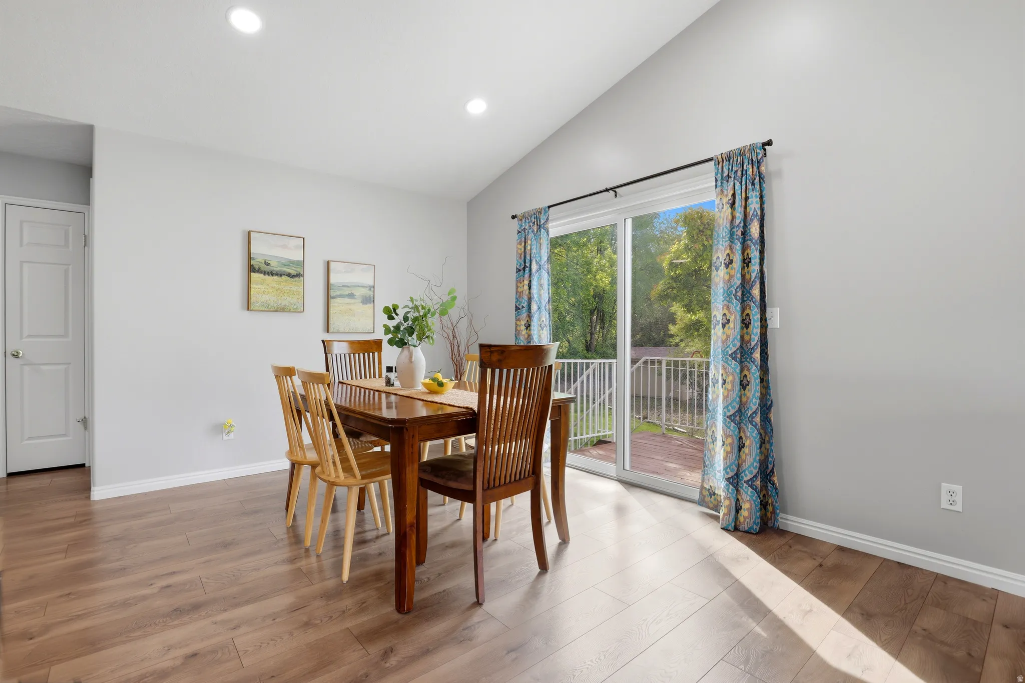 Dining room featuring lofted ceiling, light wood-style flooring, and recessed lighting