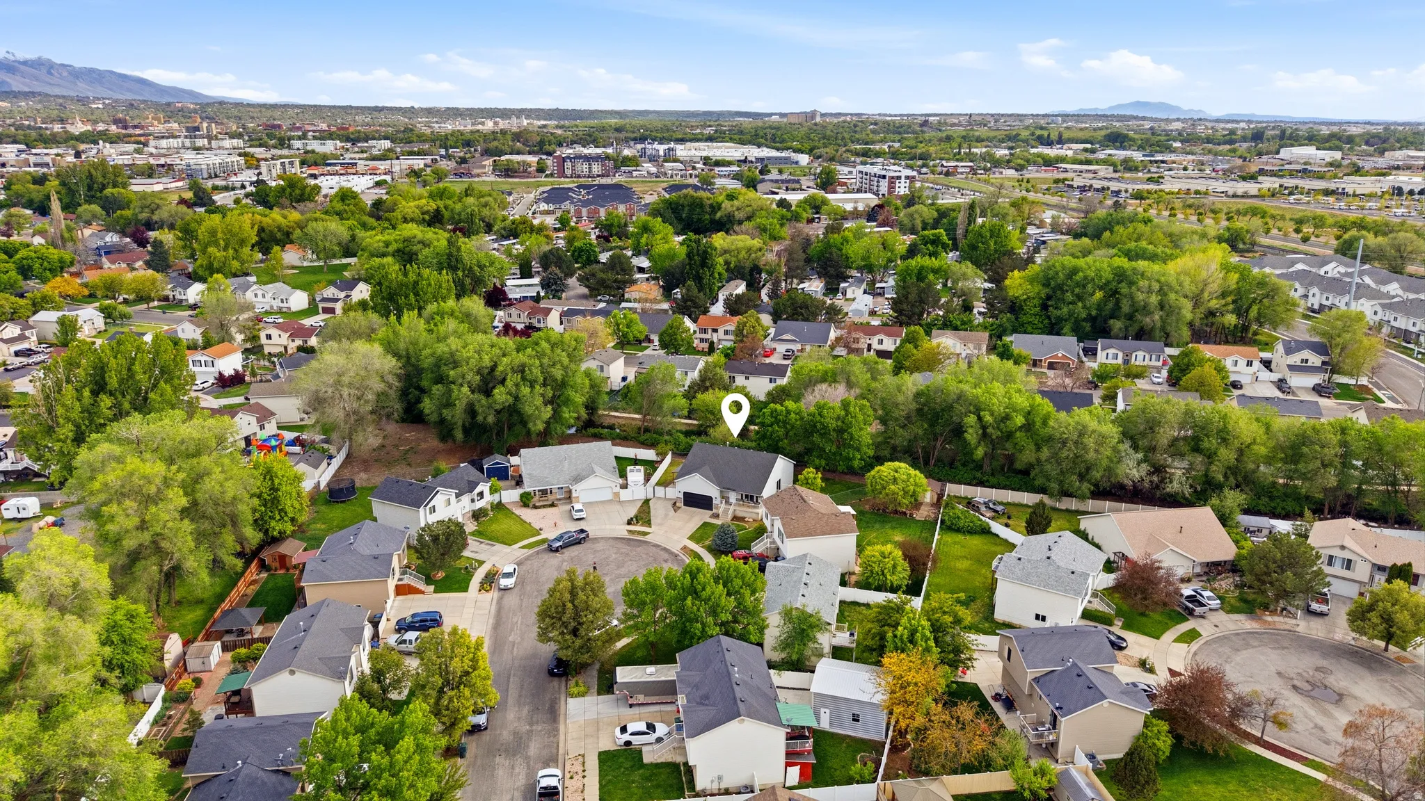 Aerial view of property's location featuring a mountain backdrop and nearby suburban area