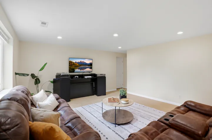 Living area featuring recessed lighting and light carpet