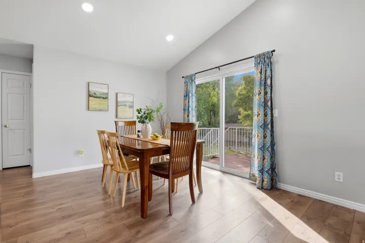 Dining room featuring lofted ceiling, light wood-style flooring, and recessed lighting