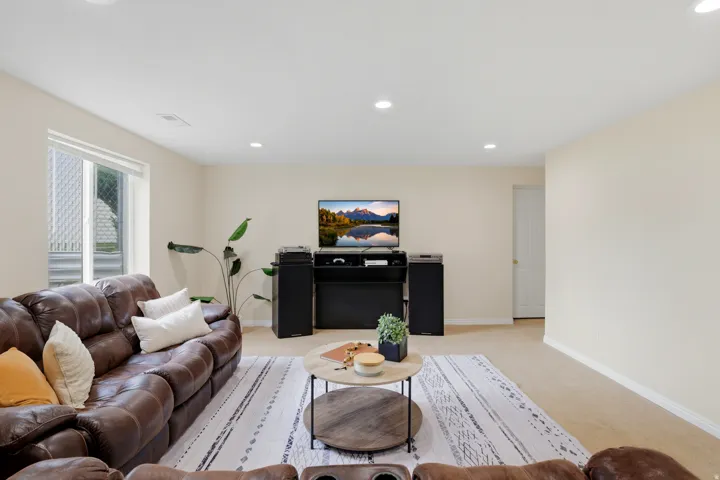 Living area featuring light carpet and recessed lighting