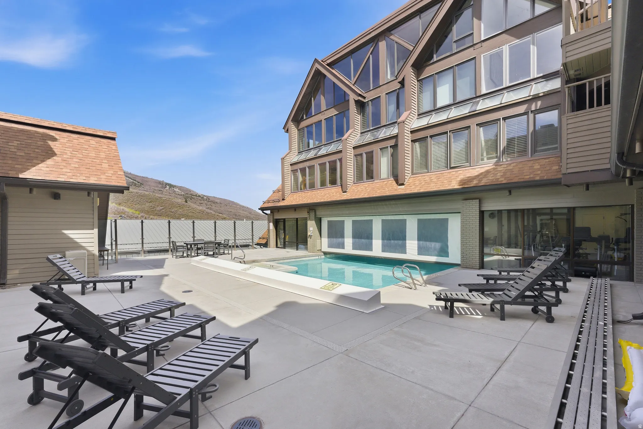 Community pool with a mountain view and a patio