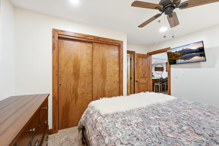 Carpeted bedroom featuring a closet, a ceiling fan, and recessed lighting