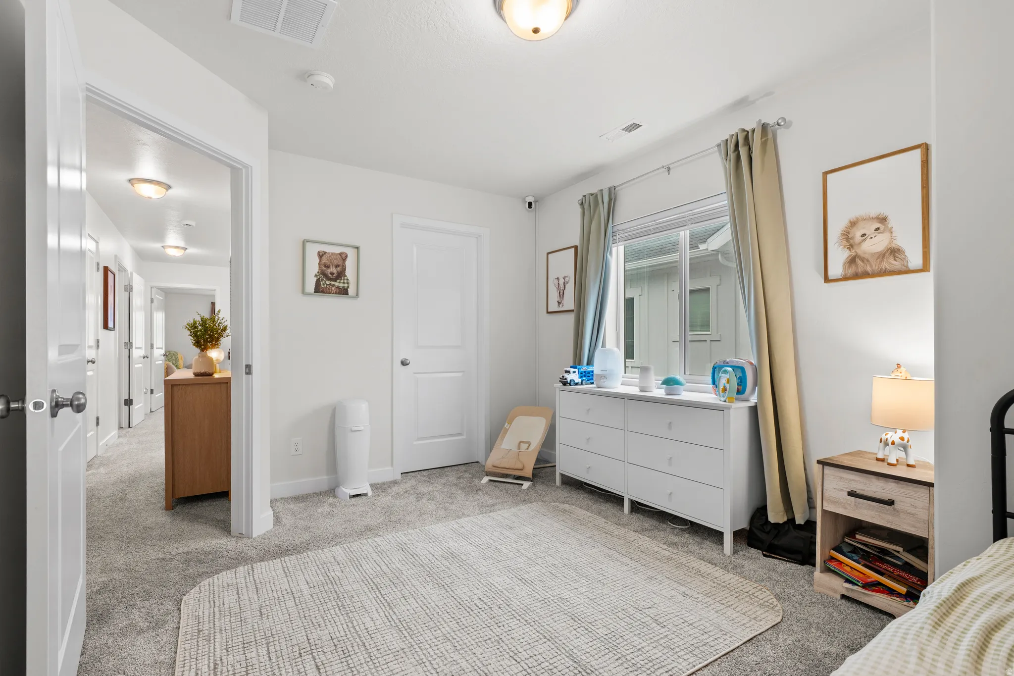 Bedroom featuring light carpet and baseboards
