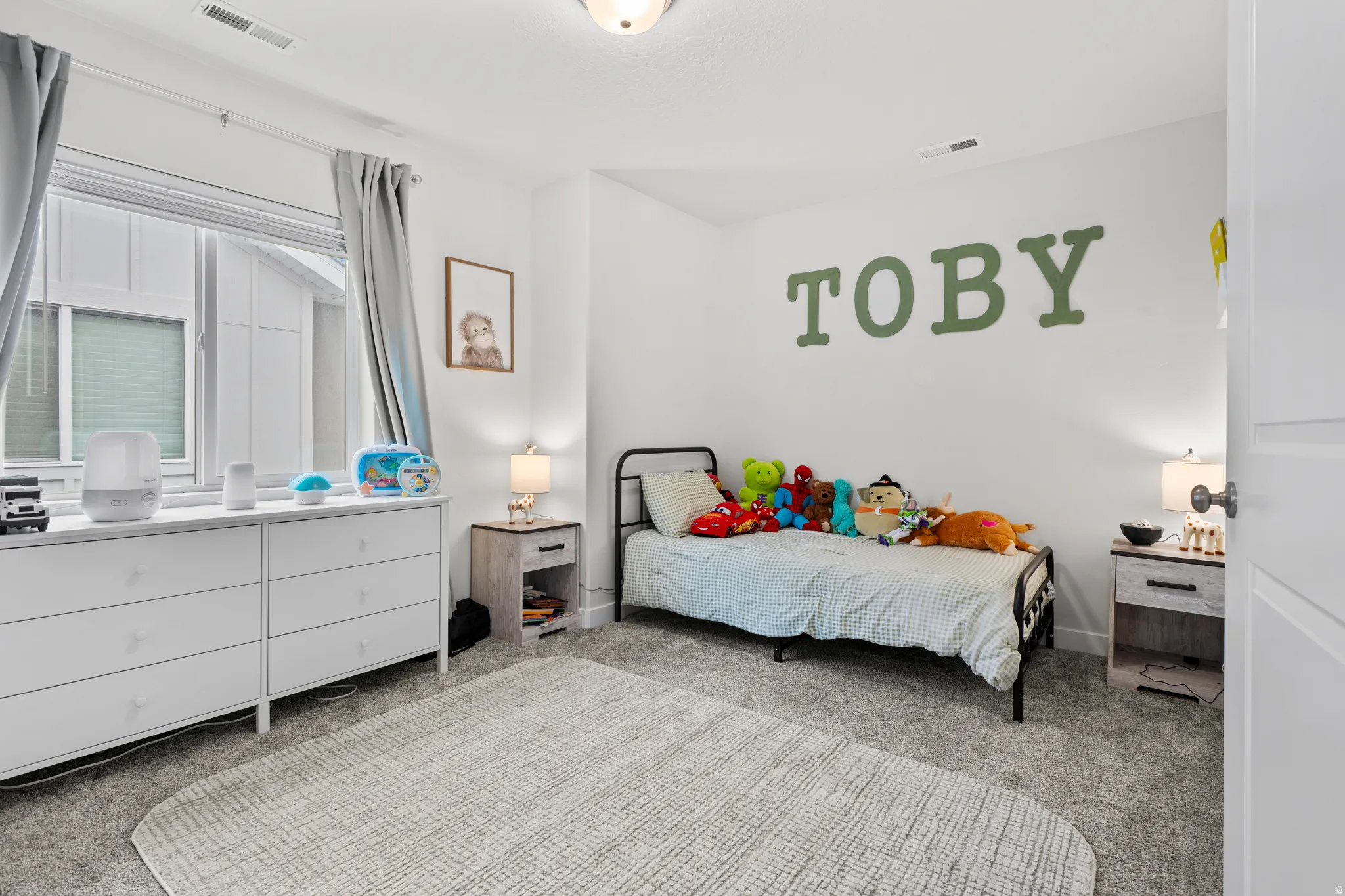 Bedroom featuring light colored carpet and baseboards