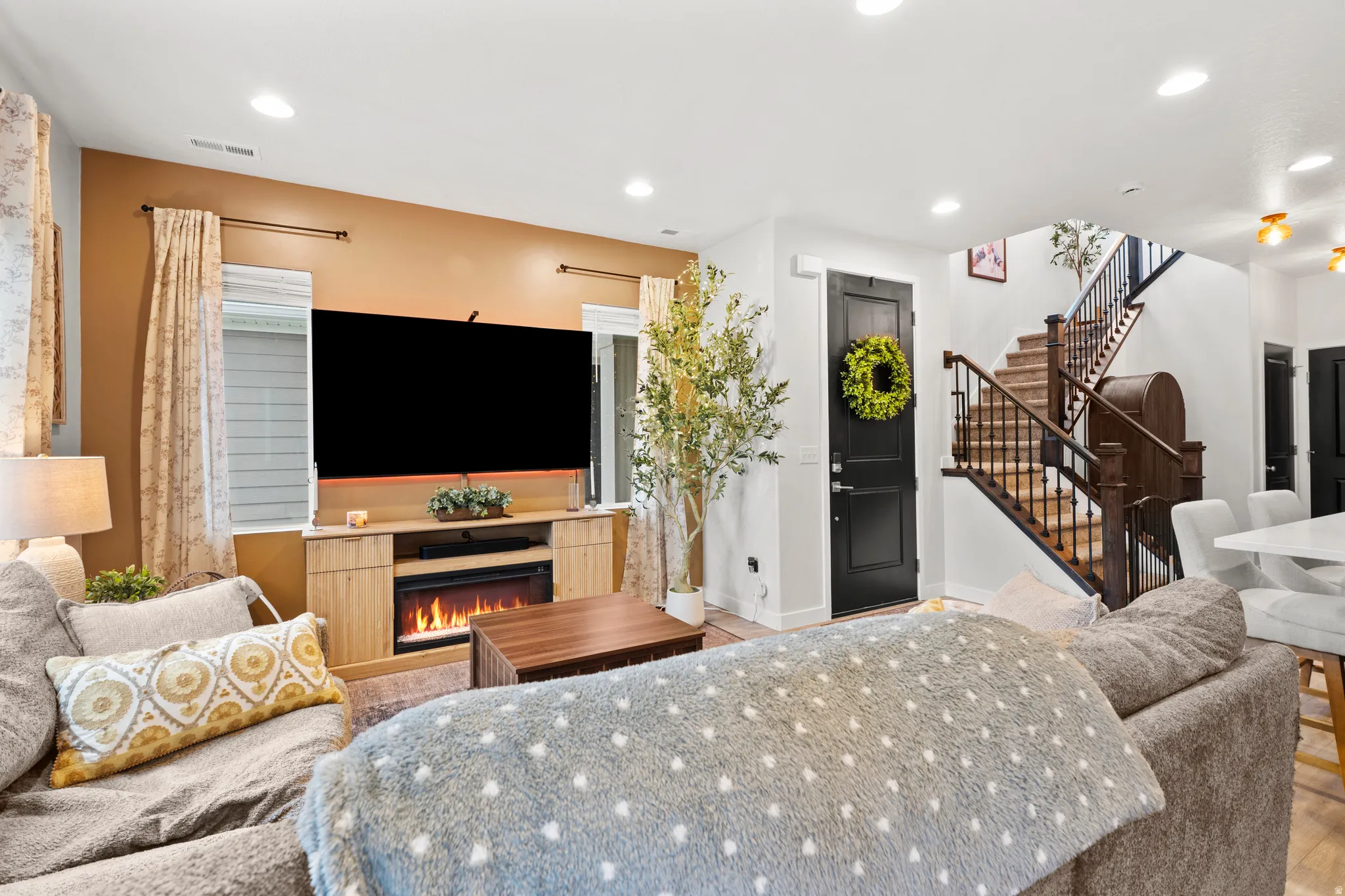 Living area featuring a lit fireplace and recessed lighting