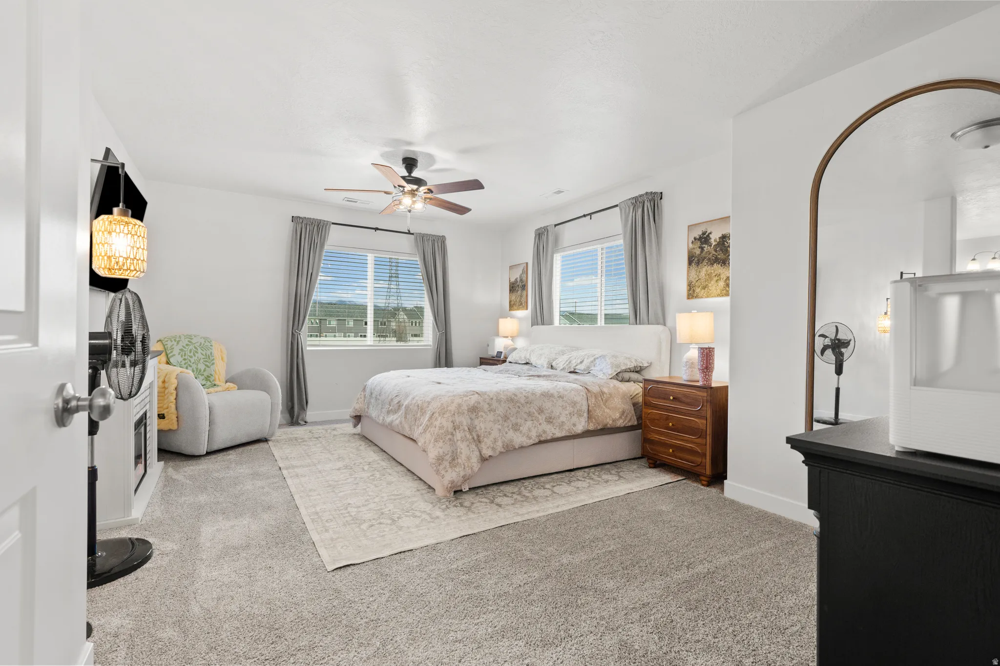 Bedroom featuring light colored carpet and ceiling fan