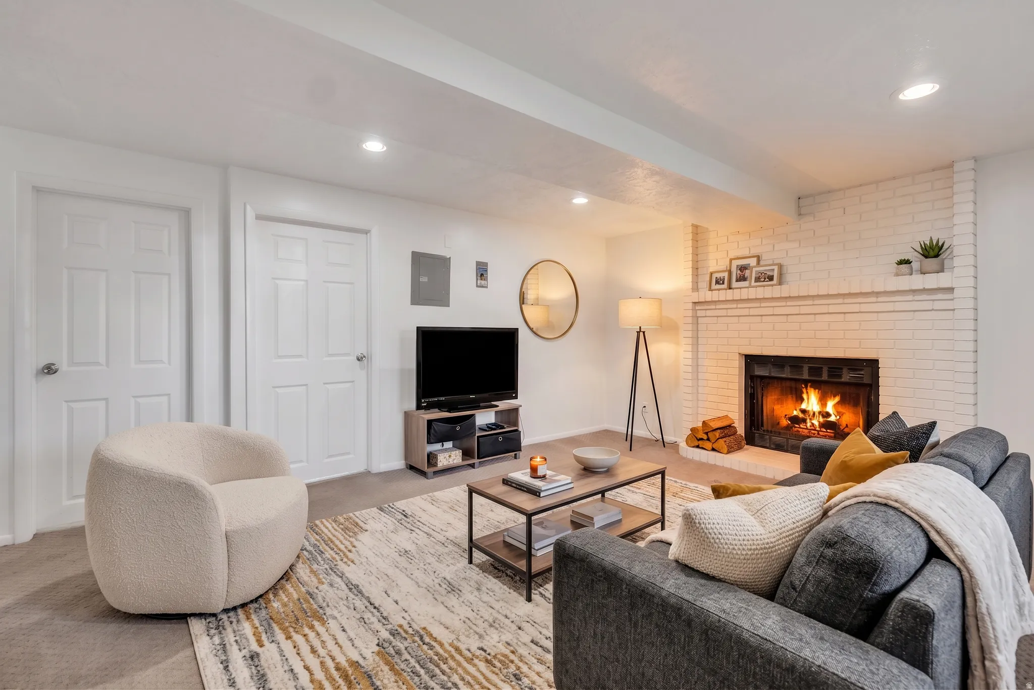 Carpeted living area with a fireplace and recessed lighting