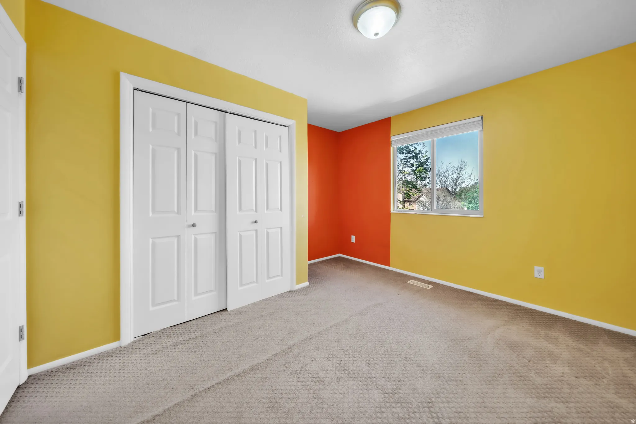 Unfurnished bedroom featuring a closet and carpet