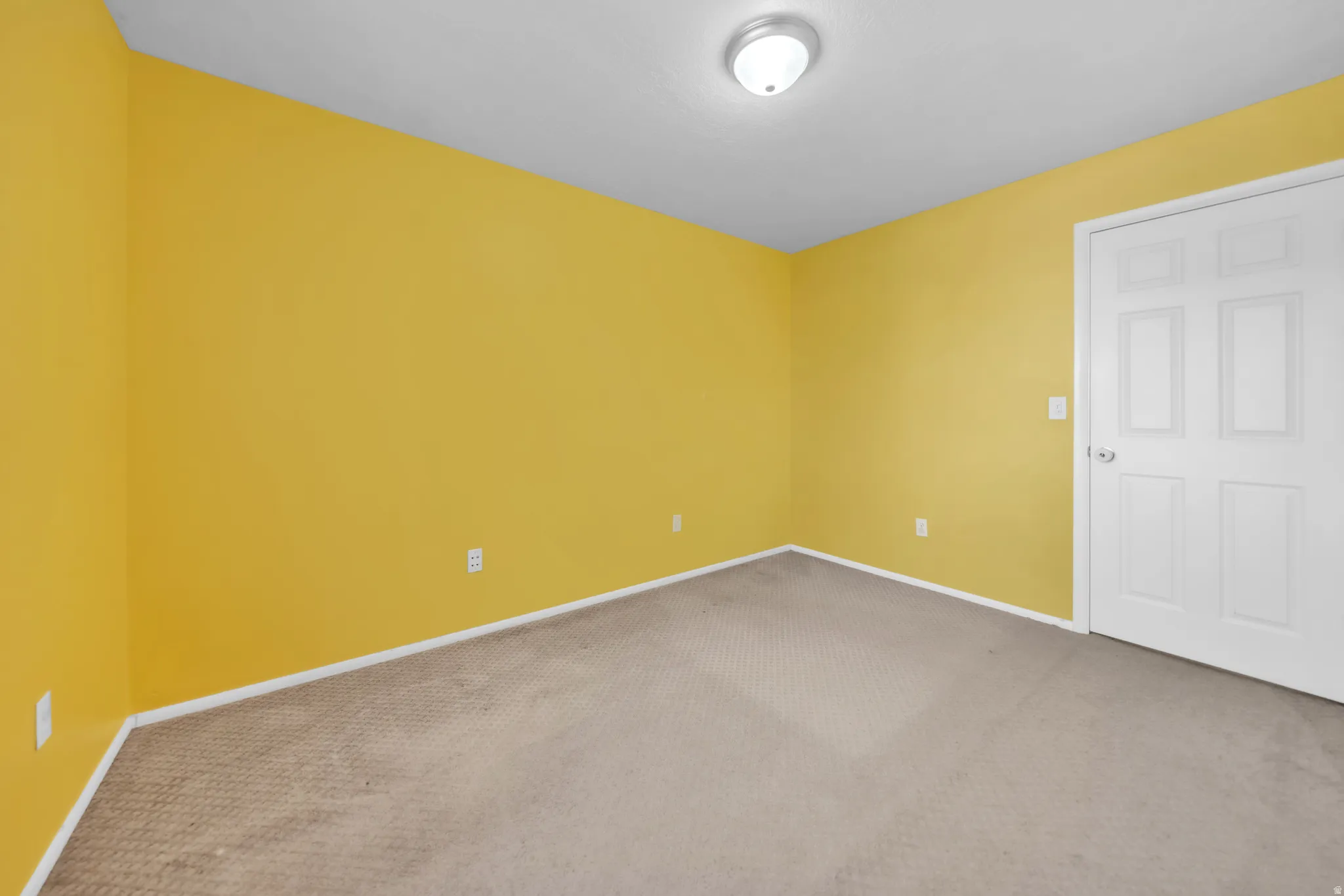 Carpeted spare room with baseboards