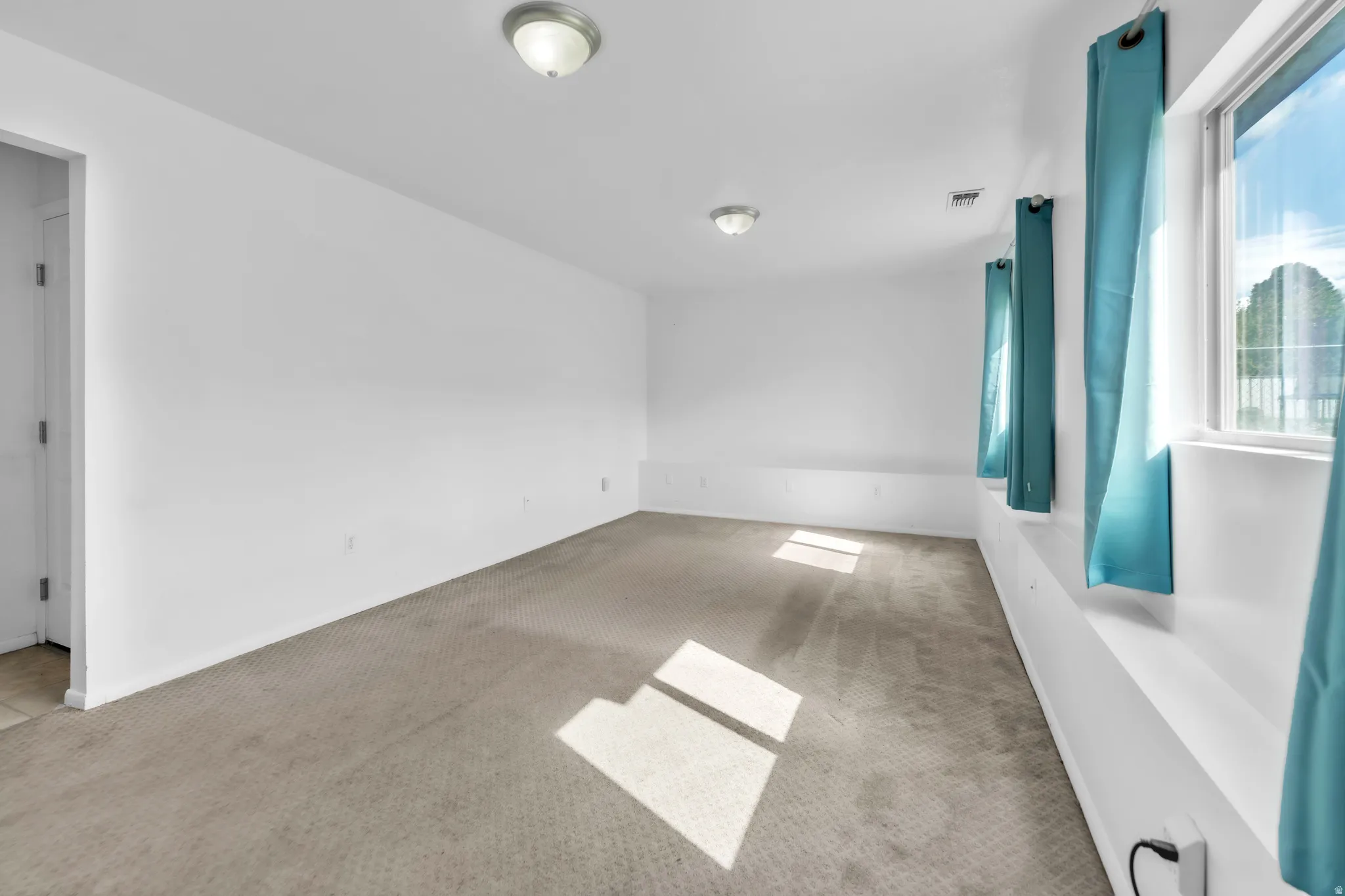 Unfurnished room featuring carpet flooring and baseboards