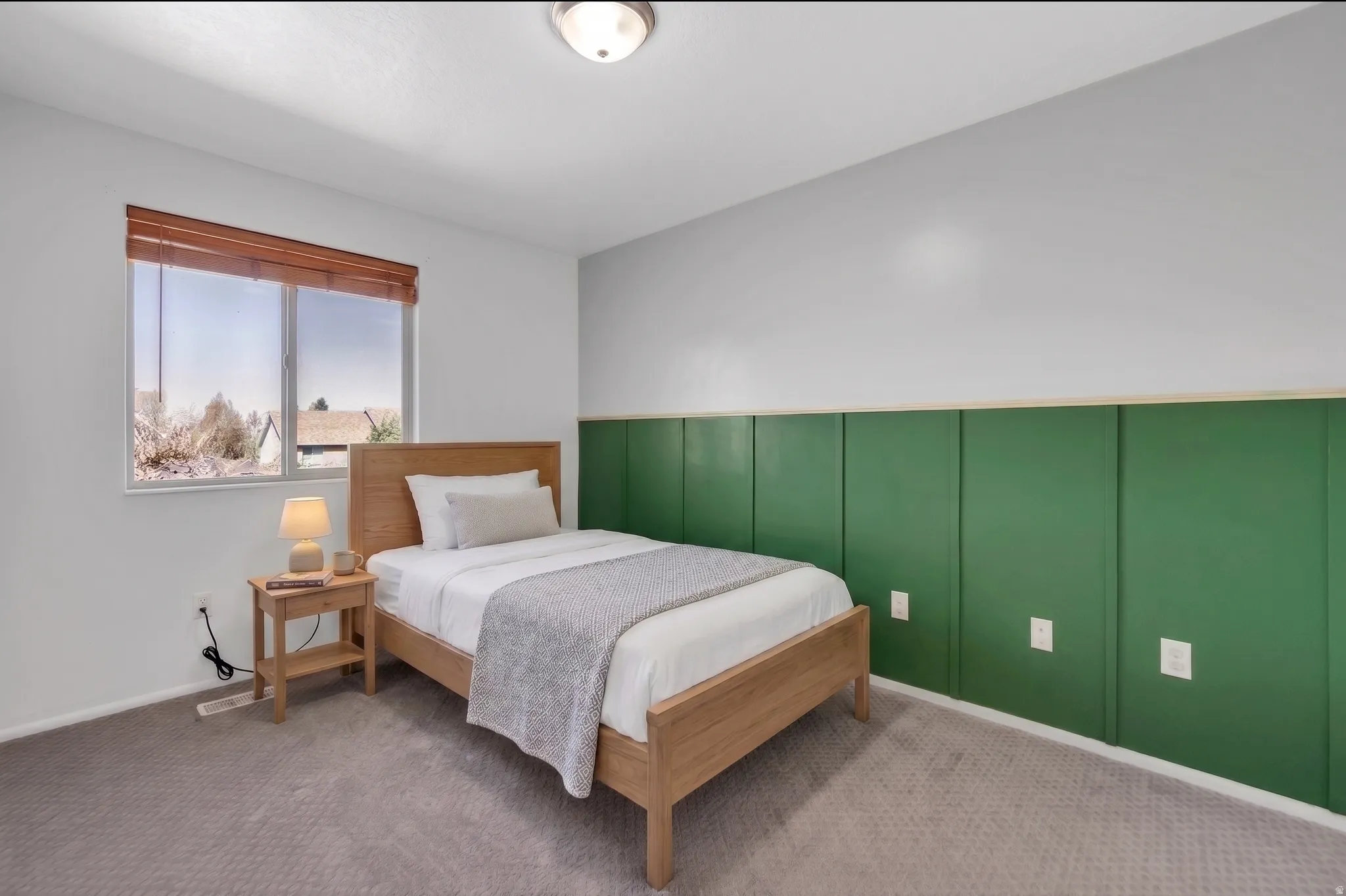 Bedroom with a decorative wall and carpet