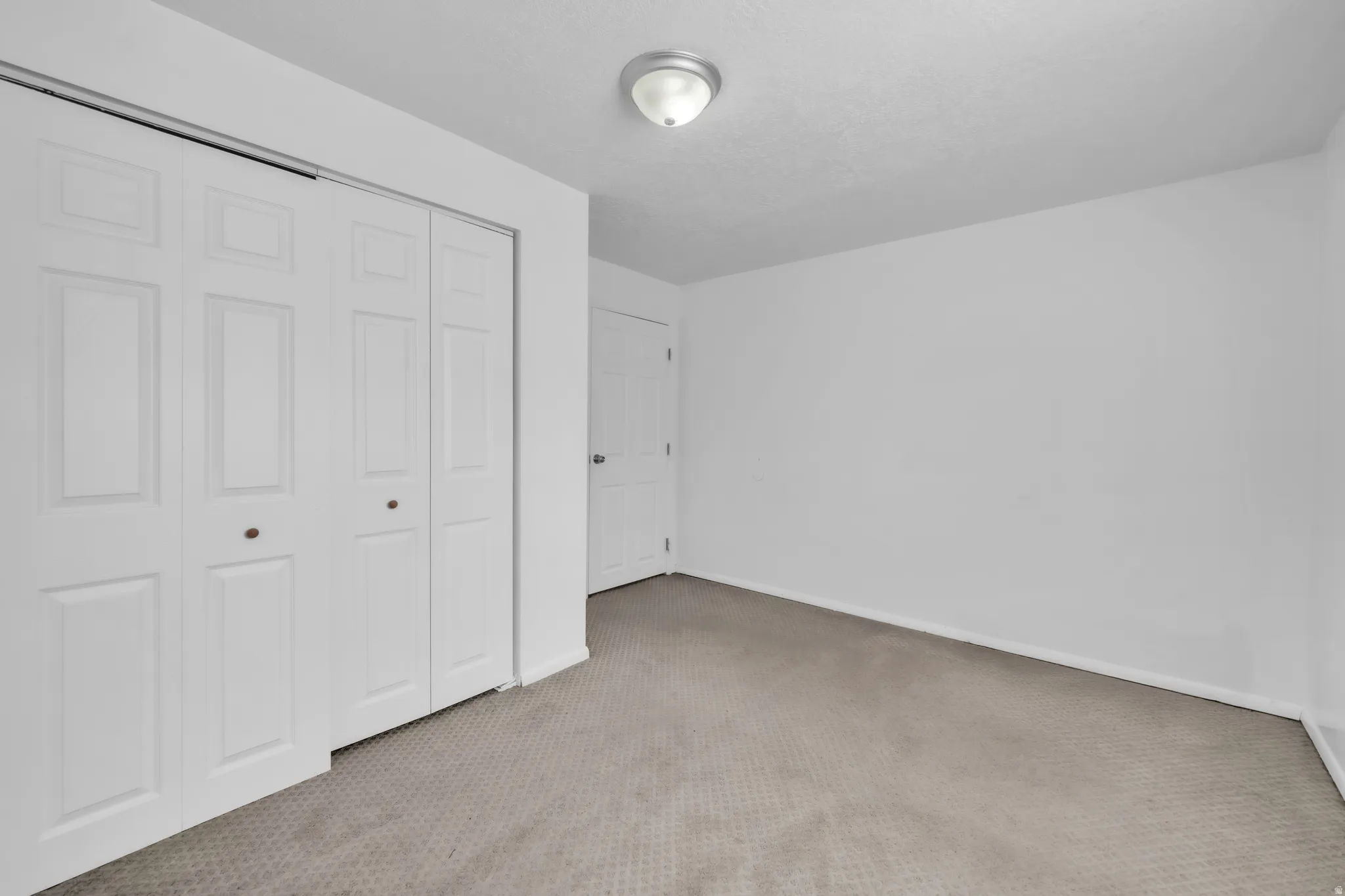 Unfurnished bedroom featuring a closet and carpet