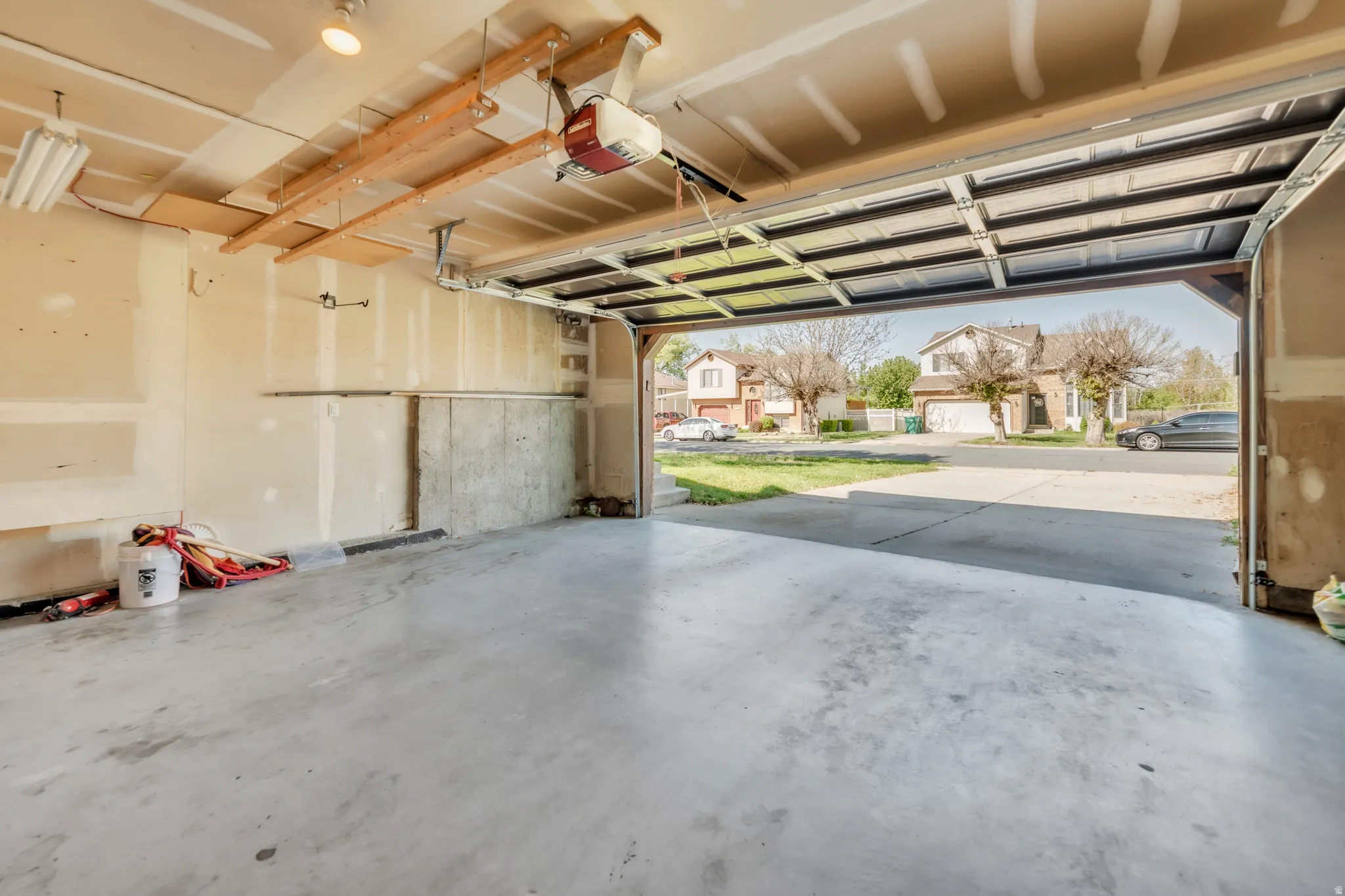 Garage with a residential view and a garage door opener