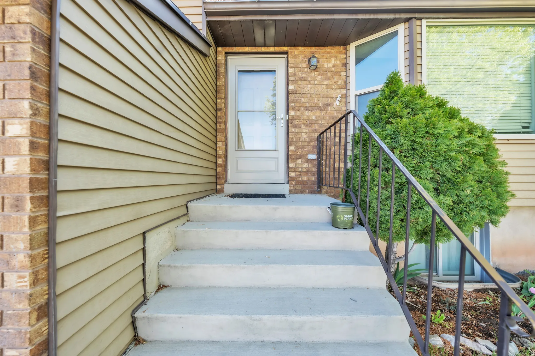 View of exterior entry with brick siding