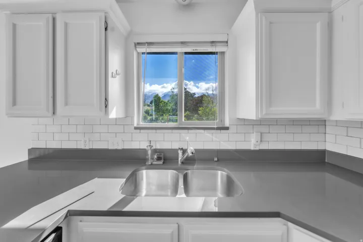 Kitchen featuring white cabinets and decorative backsplash