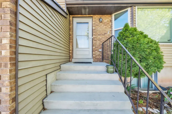 View of exterior entry with brick siding