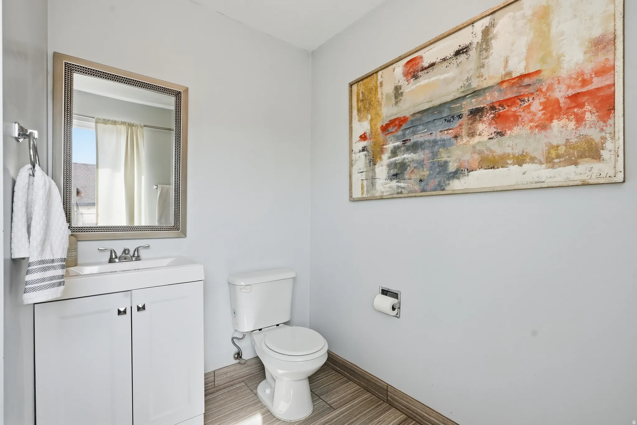 Bathroom featuring a shower with shower curtain and vanity
