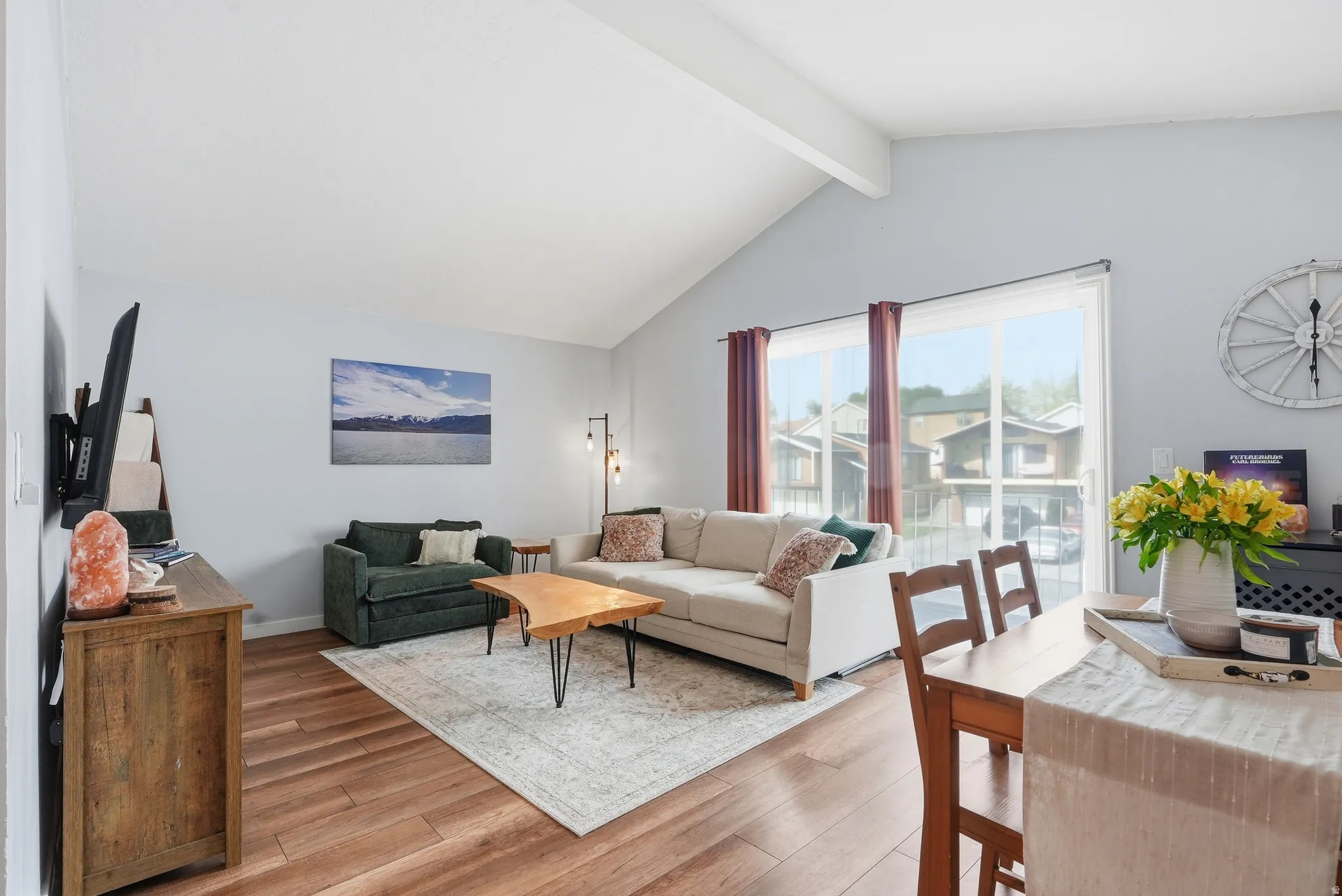 Living room featuring light wood-style floors and beam ceiling