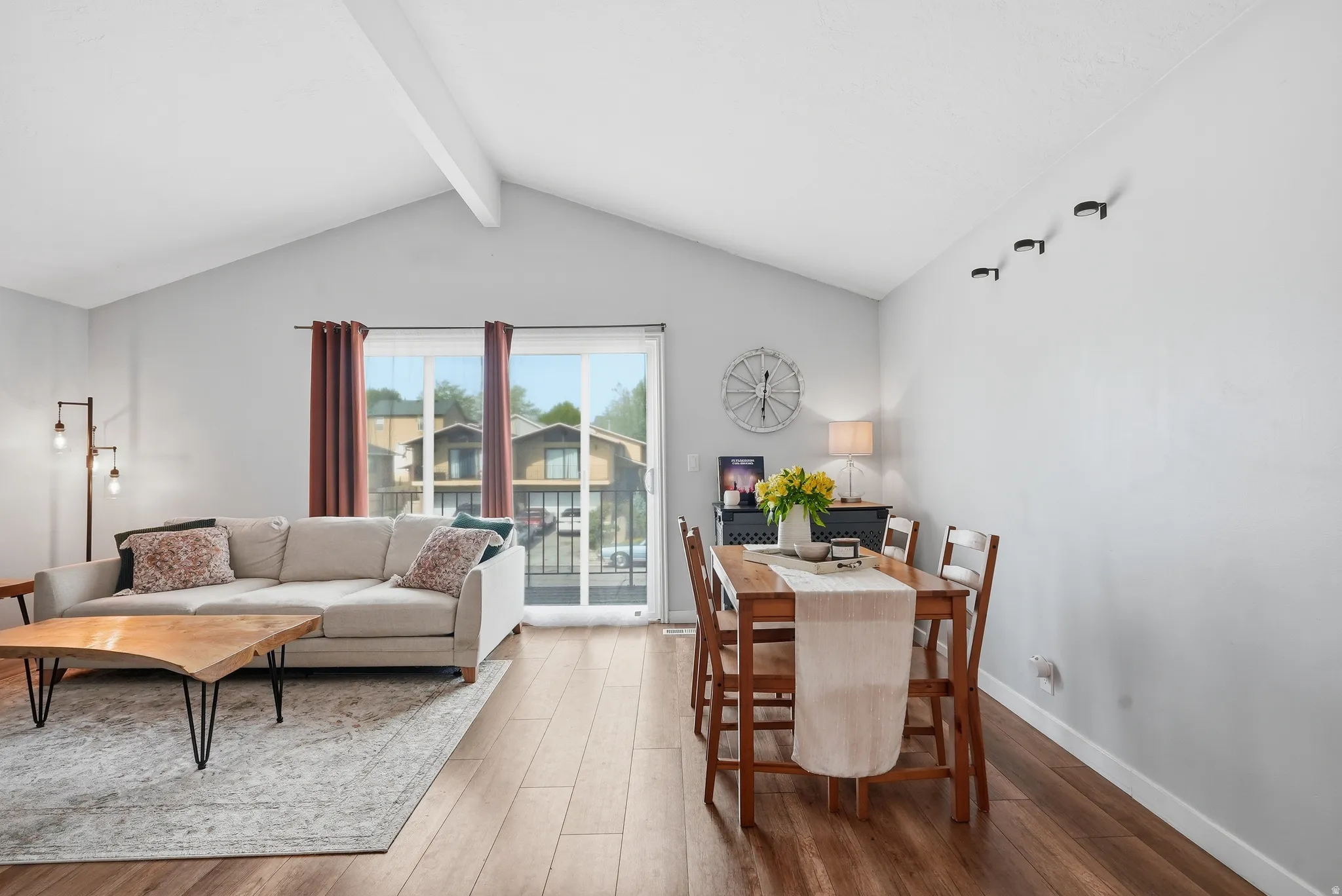 Dining room featuring wood finished floors and beam ceiling
