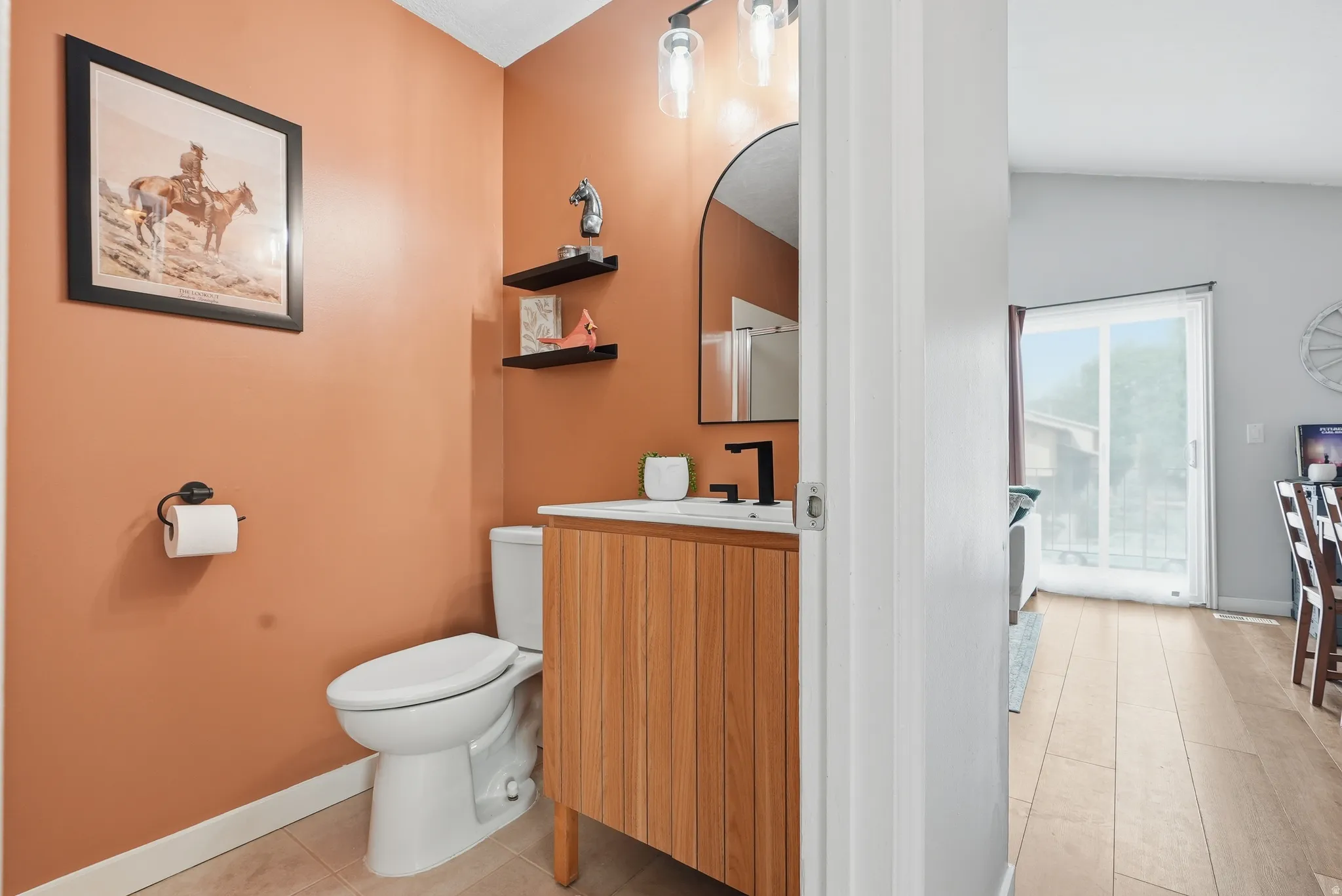 Half bathroom featuring vanity and light tile patterned flooring