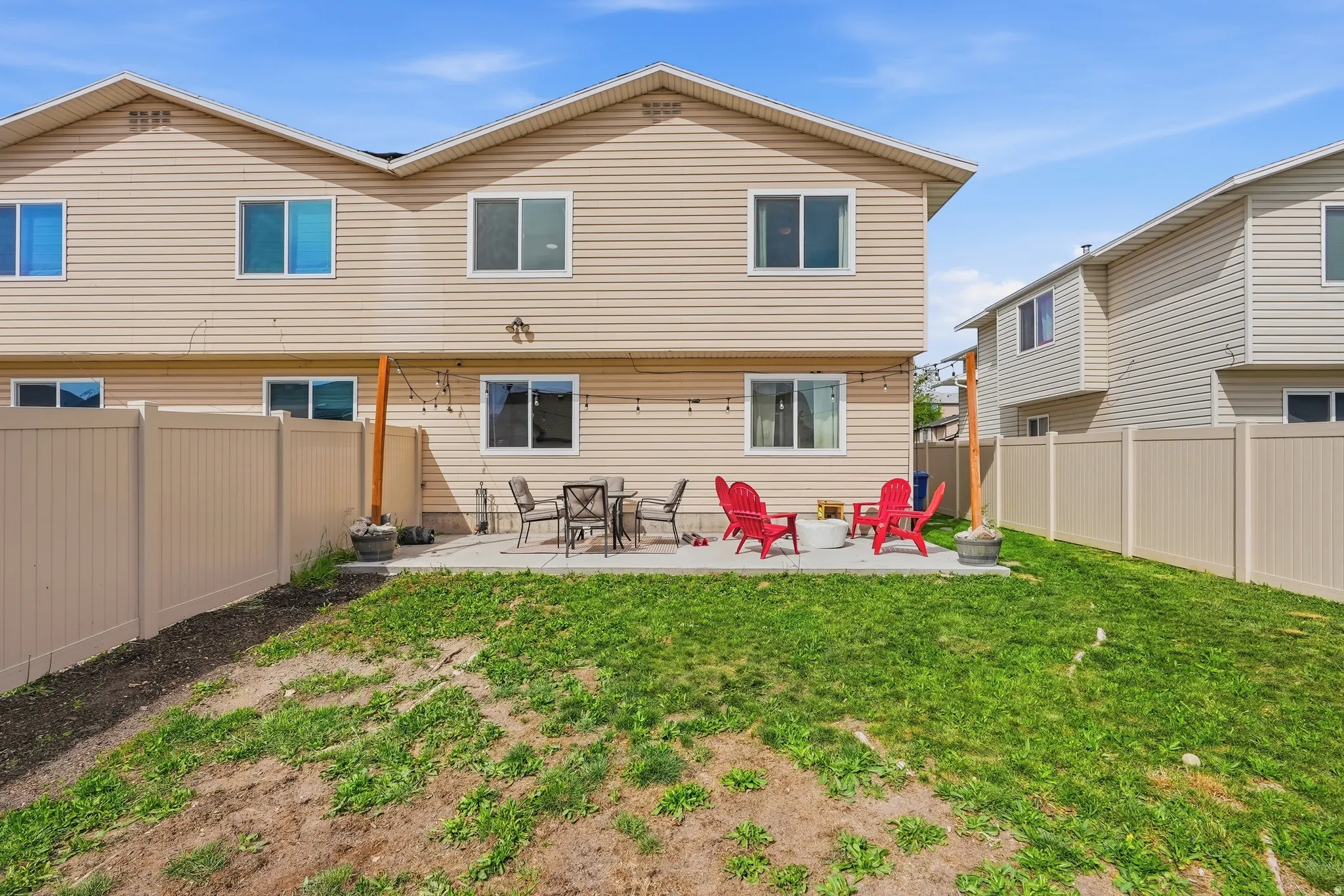 Rear view of house featuring a patio and a fenced backyard