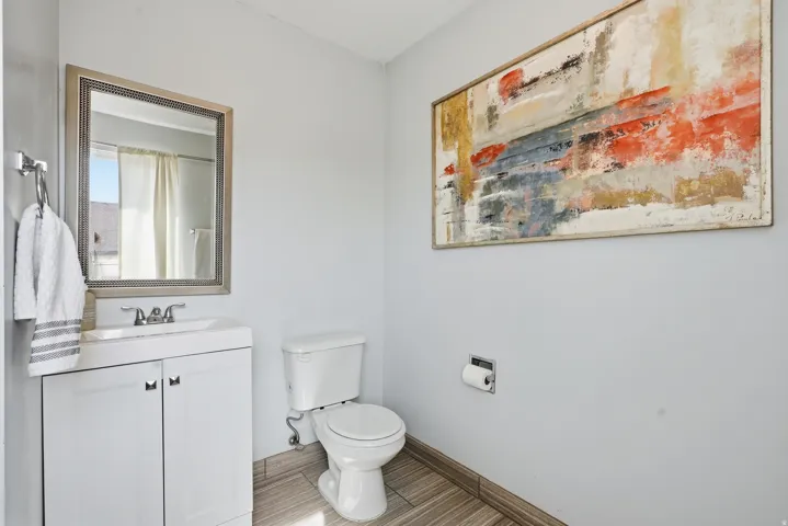 Bathroom featuring a shower with shower curtain and vanity