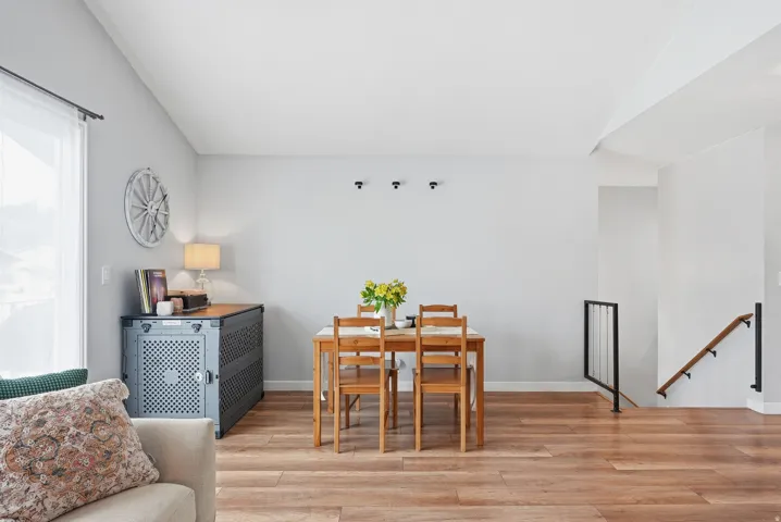 Dining room with light wood-style floors and lofted ceiling