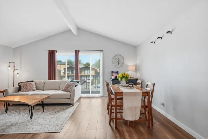 Dining room featuring wood finished floors and beam ceiling