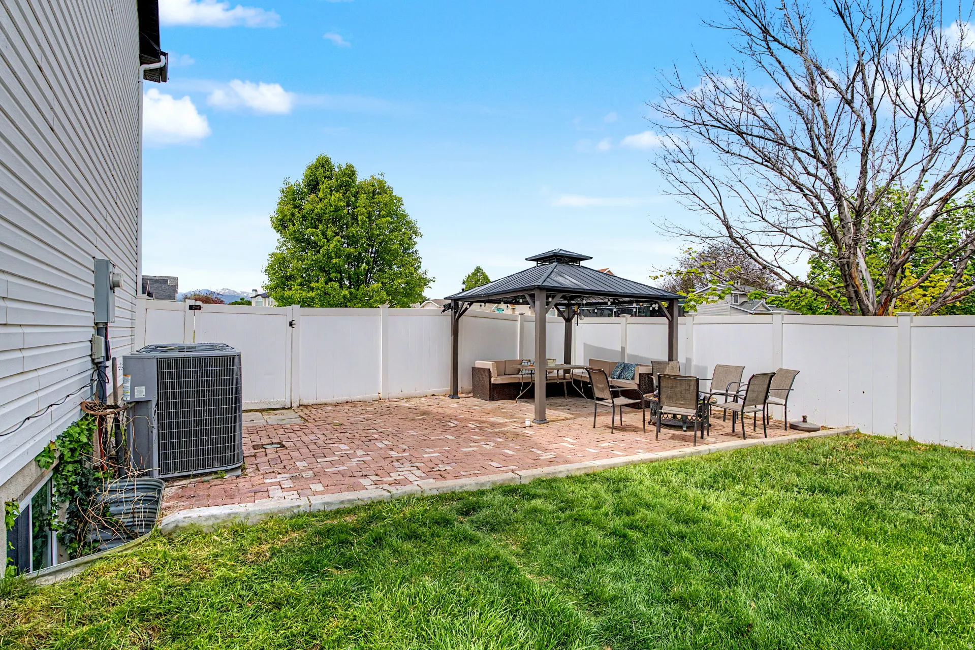 Fenced backyard with a patio area and a gazebo