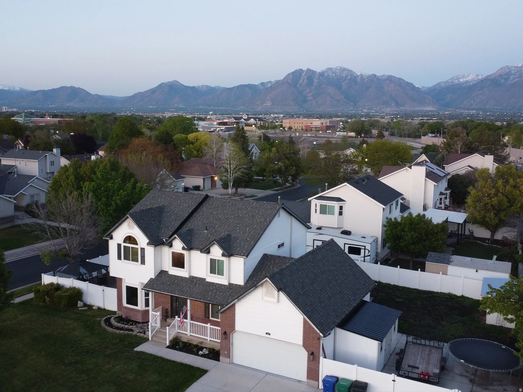 Aerial perspective of suburban area with a mountainous background