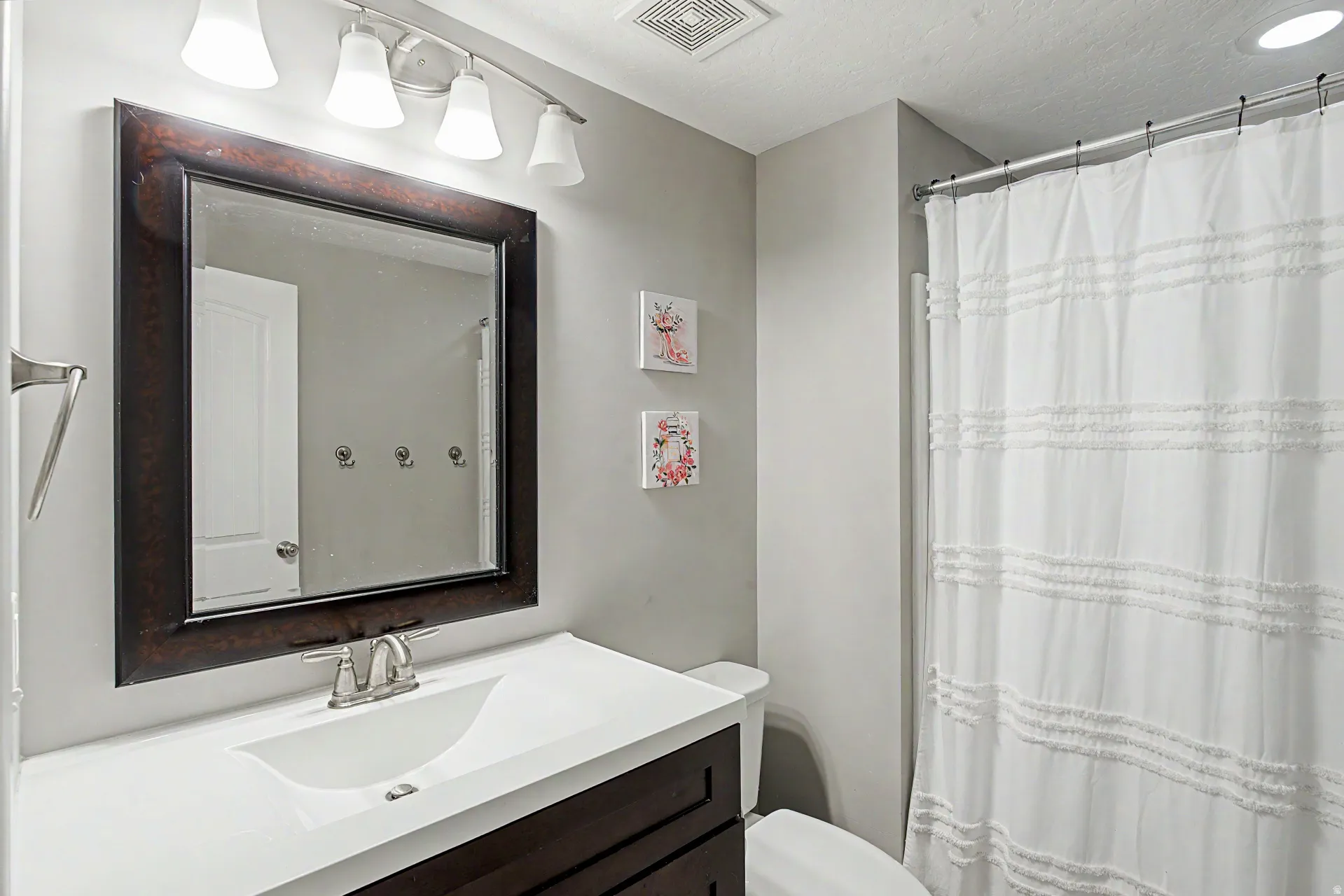 Full bathroom featuring vanity and curtained shower