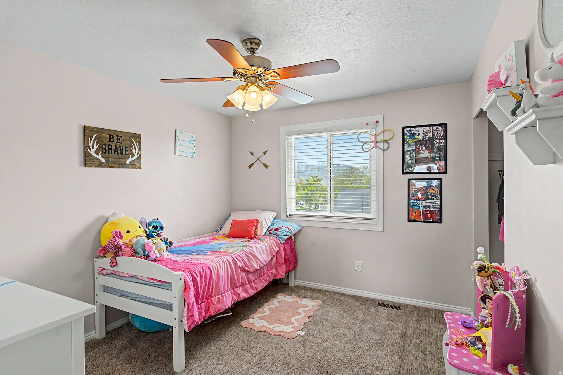 Bedroom featuring dark carpet, a ceiling fan, and a textured ceiling