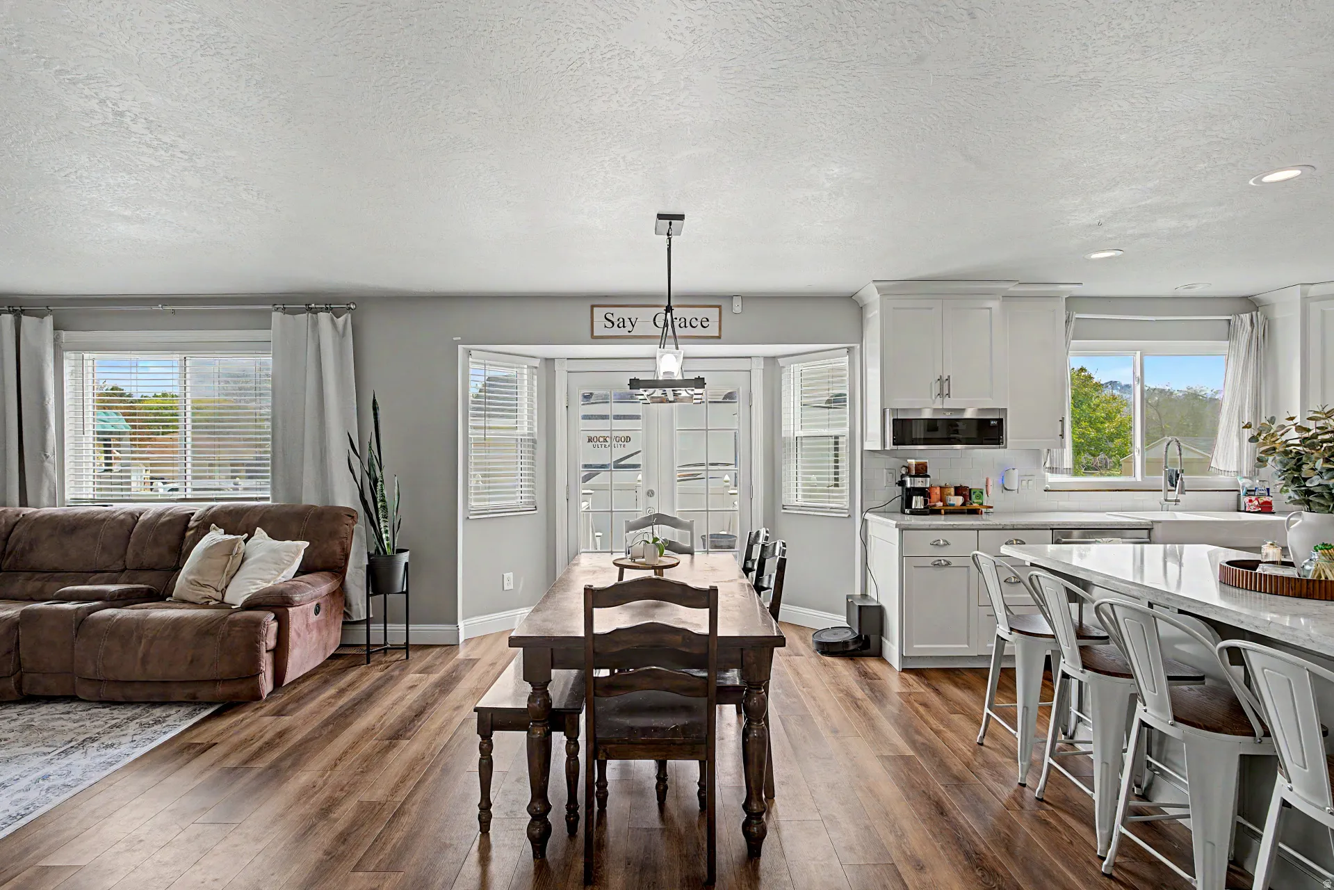 Dining area featuring dark wood-type flooring and a textured ceiling