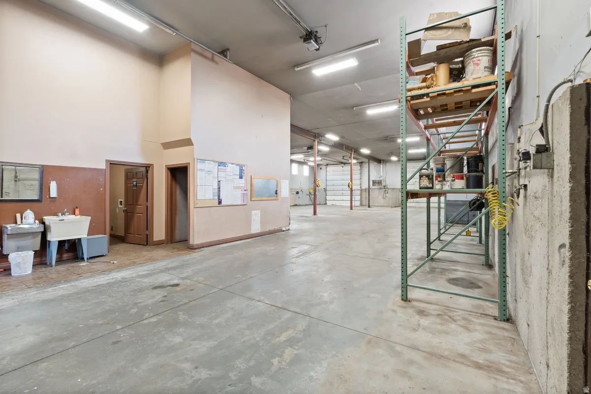 Misc room with a garage and a high ceiling