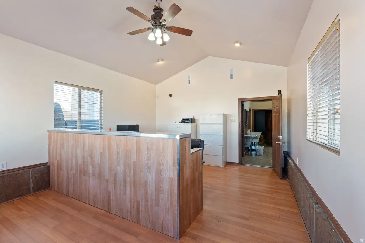 Welcome area featuring a ceiling fan and lofted ceiling
