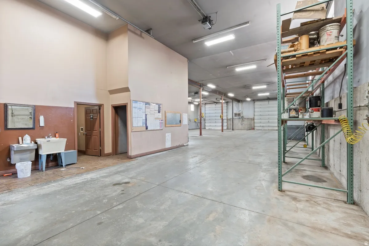 Miscellaneous room with a garage and a high ceiling
