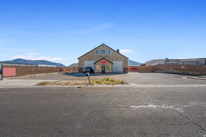 View of front of property featuring a mountain view and an outdoor structure