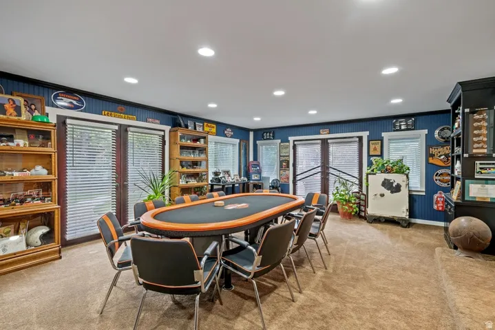 Recreation room featuring light carpet, healthy amount of natural light, recessed lighting, and ornamental molding