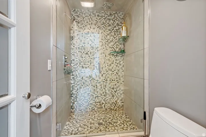 Full bath with a stall shower and toilet