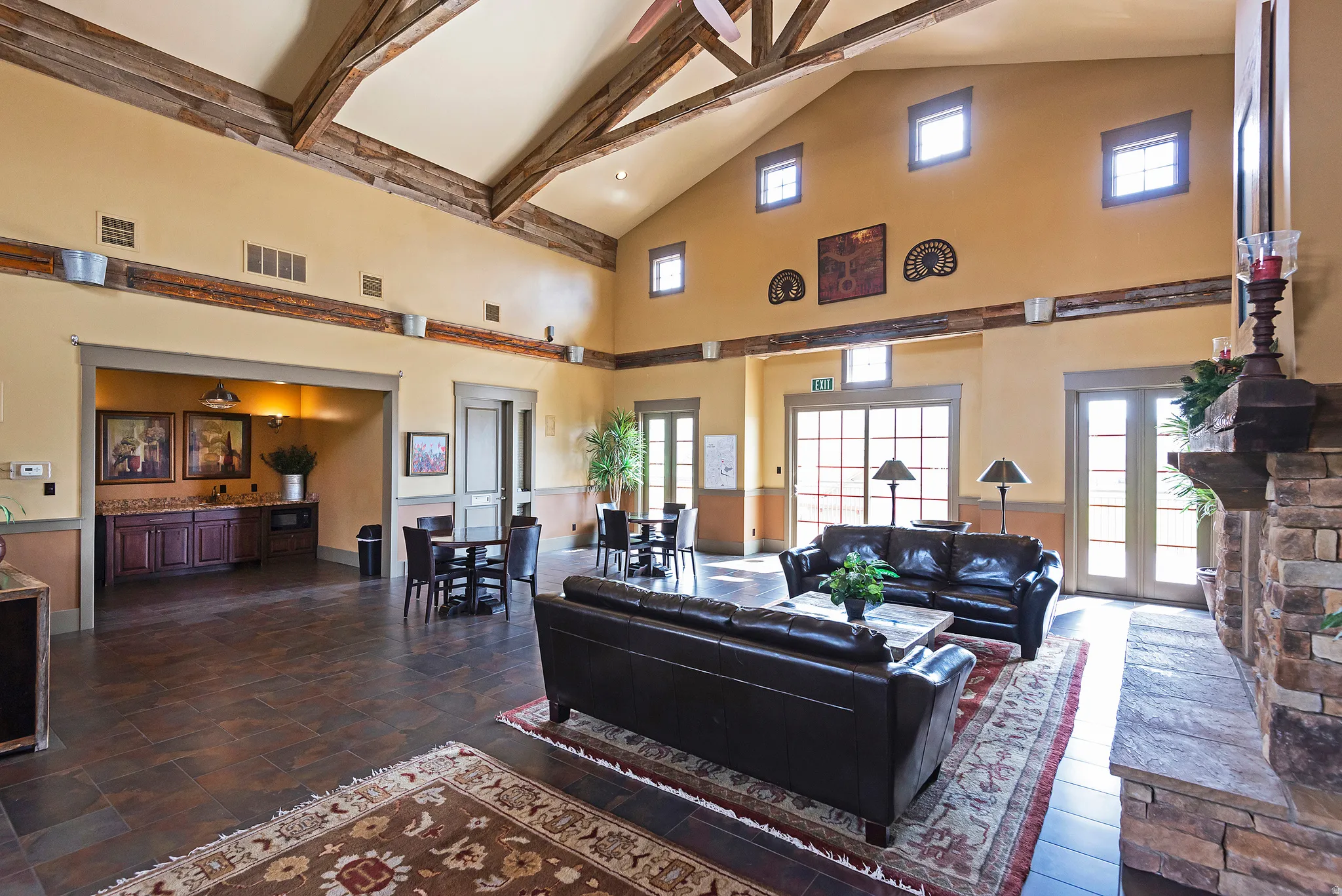 Living room with lofted ceiling and a wainscoted wall