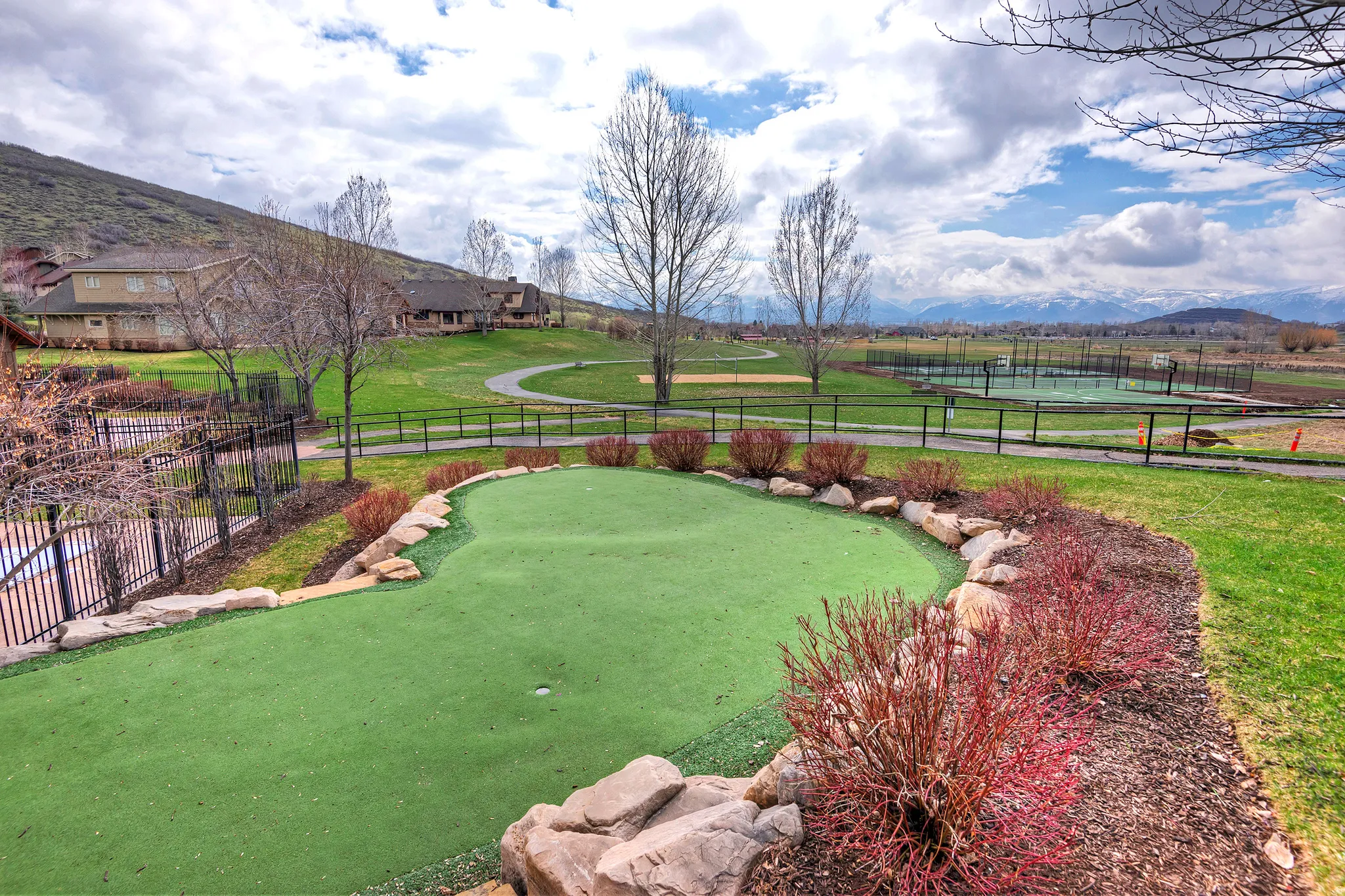 View of property's community with an area to practice putting and a mountain view