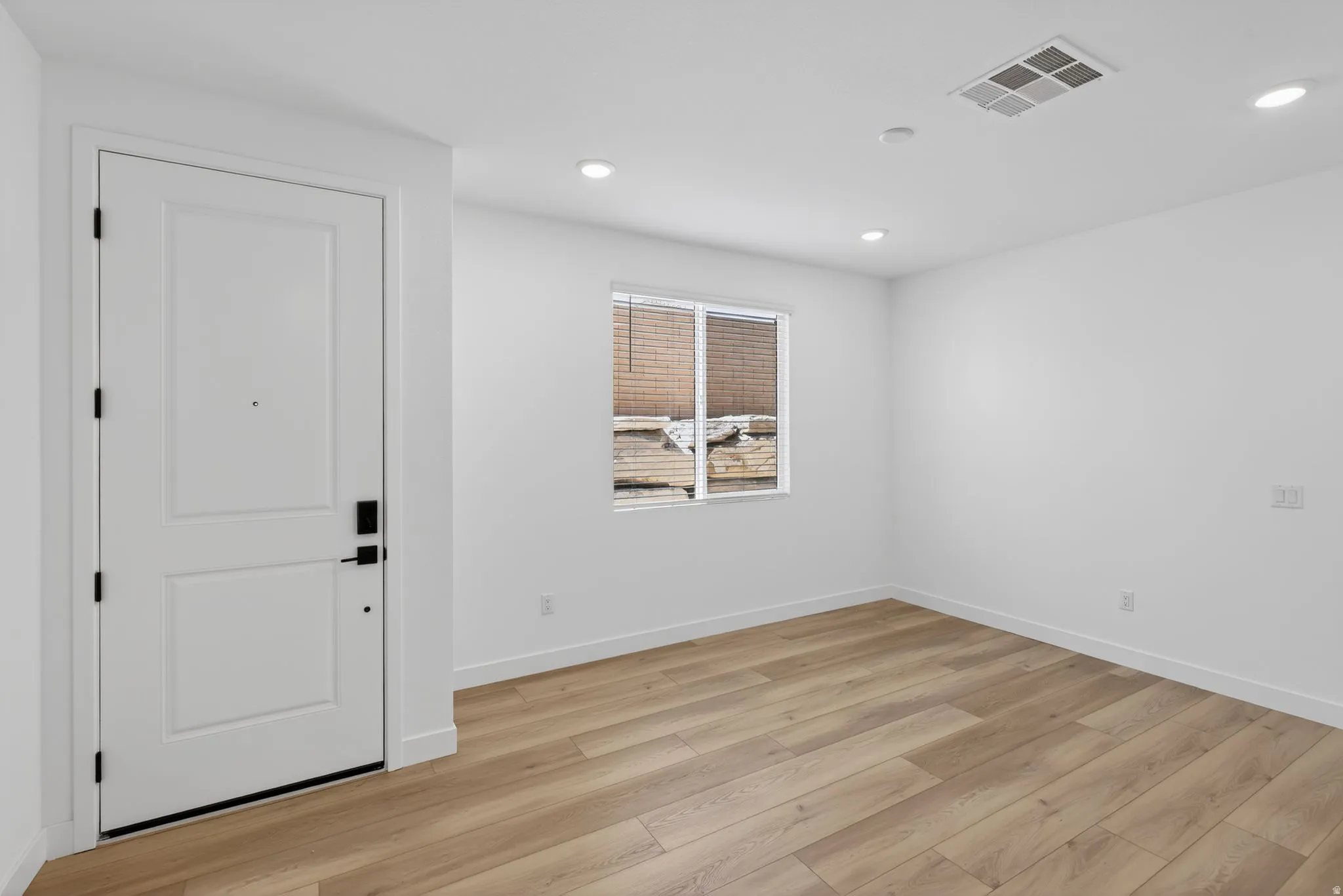 Spare room with light wood-type flooring and recessed lighting