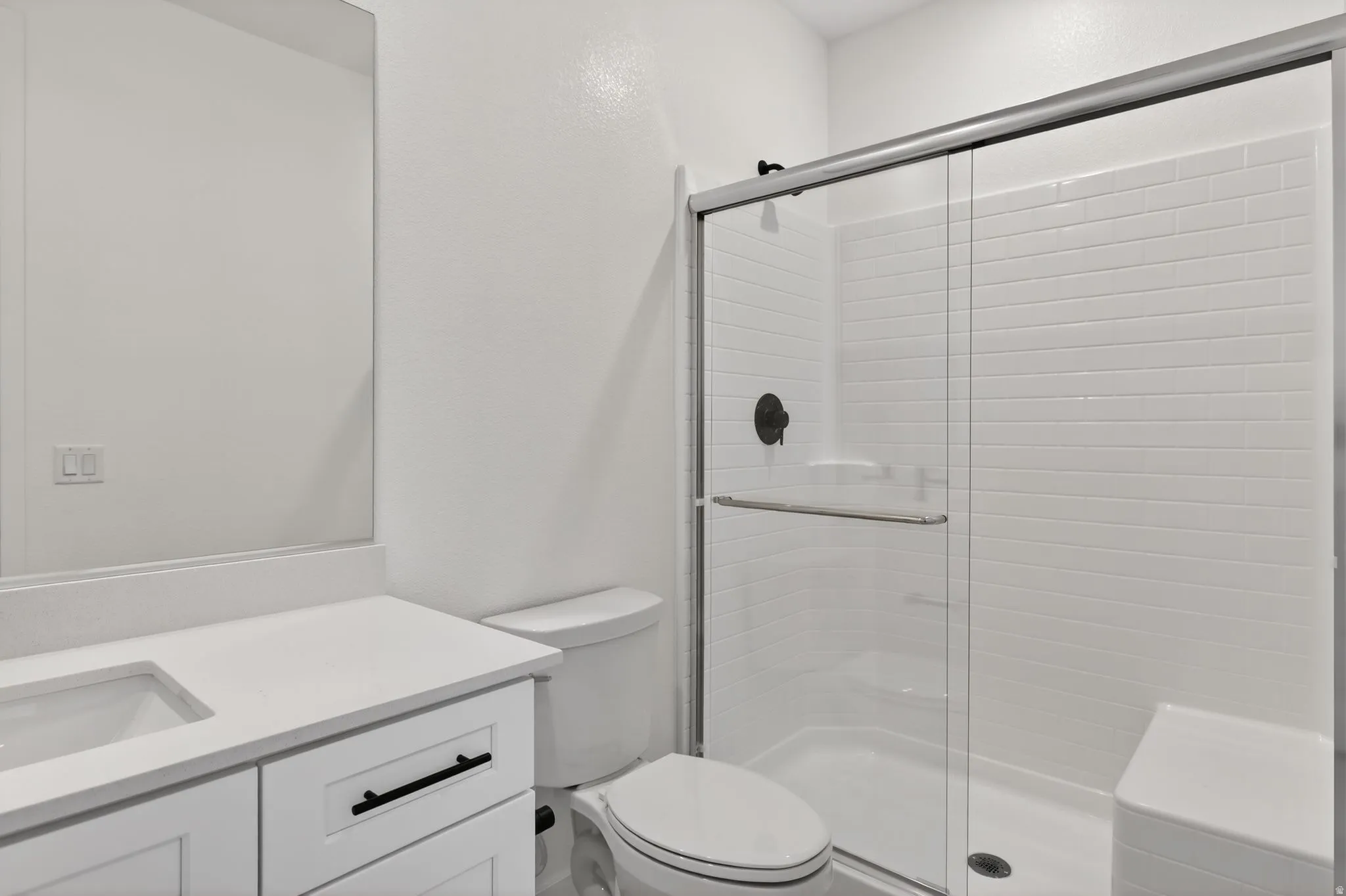 Full bathroom featuring vanity and a stall shower