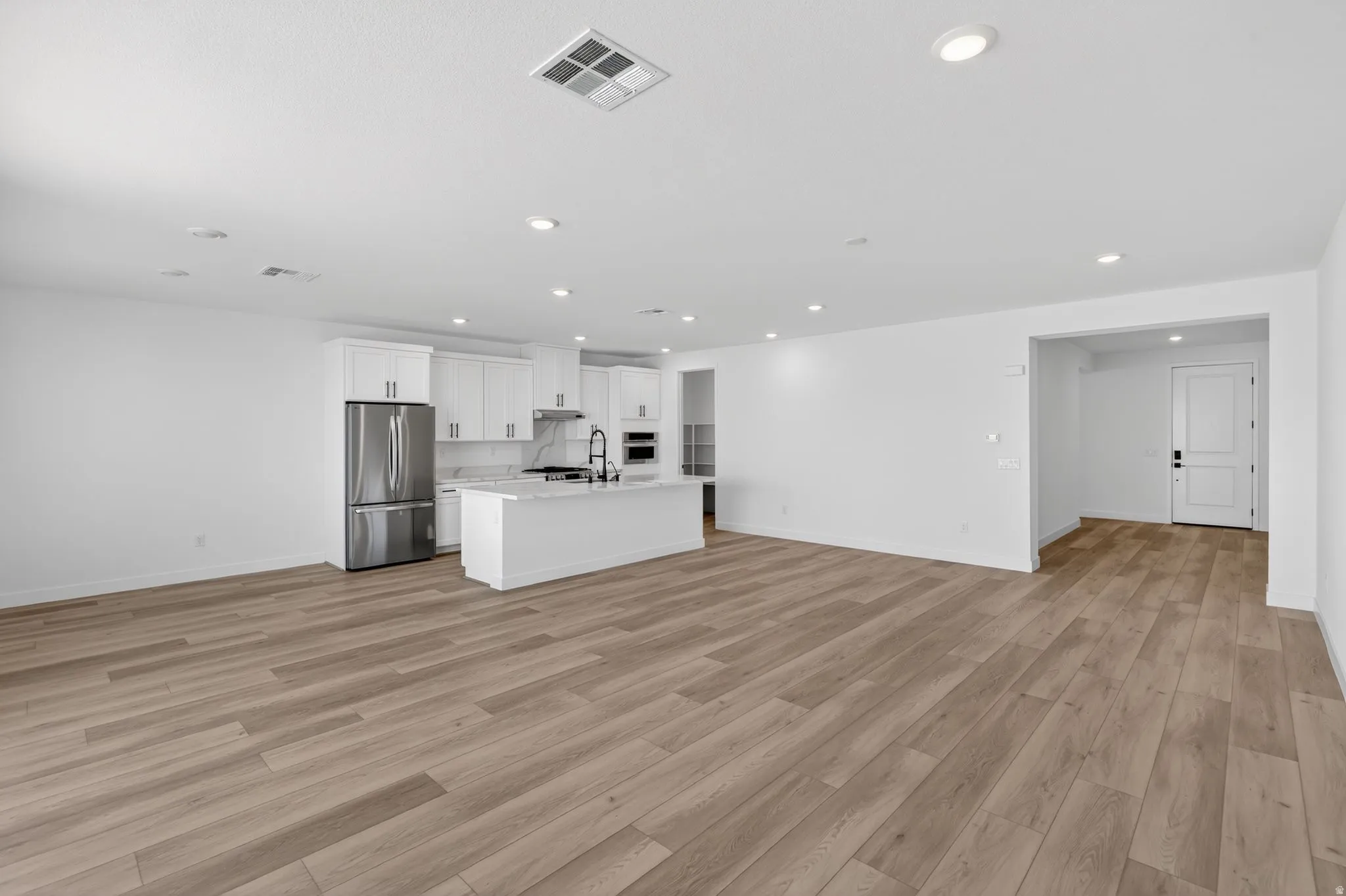 Unfurnished living room with recessed lighting and light wood-style flooring